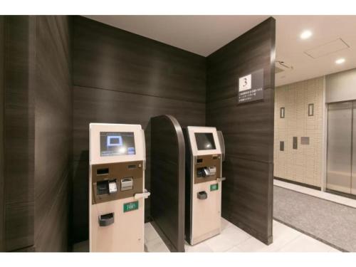 an atm machine in a room with a wall at R&B Hotel Shin Osaka Kitaguchi - Vacation STAY 40553v in Osaka