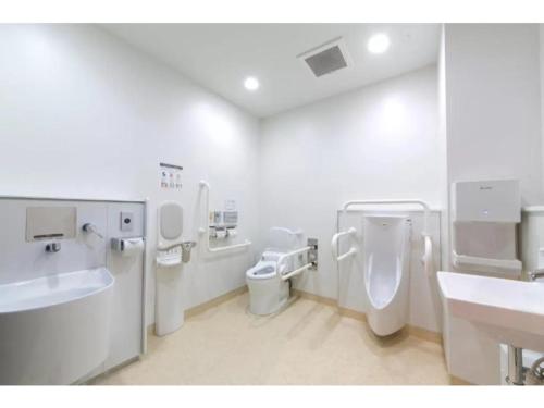 a bathroom with a sink and a toilet and sinks at R&B Hotel Shin Osaka Kitaguchi - Vacation STAY 40554v in Osaka