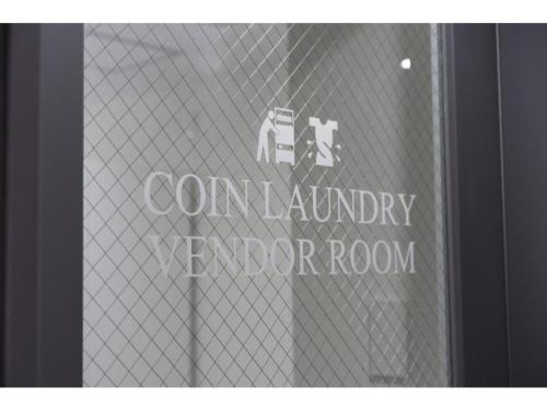 a window with a sign that says corn laundry elevator room at R&B Hotel Hakata Ekimae 2 - Vacation STAY 40722v in Fukuoka