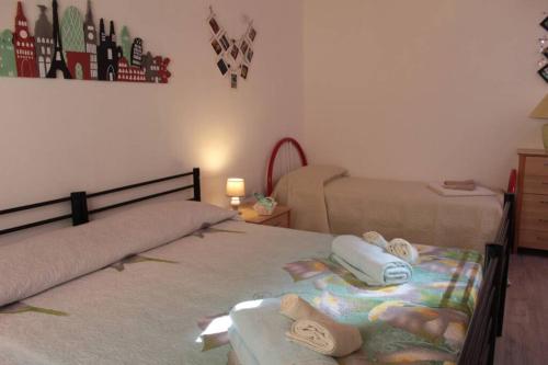 a bedroom with two beds with towels on them at B&B la piccola maison in Ploaghe