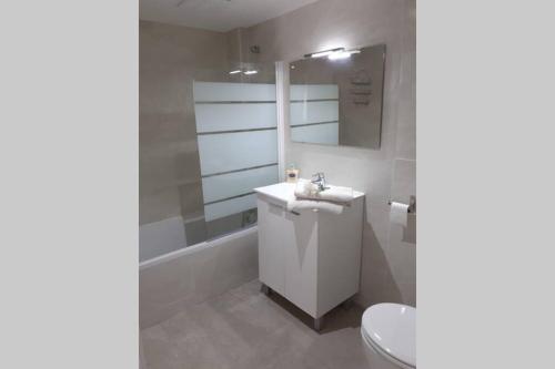 a bathroom with a white sink and a toilet at Bright and central 2 bedroom flat in Gibraltar in Gibraltar