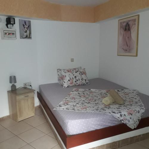a small bedroom with a bed and a night stand at Ground Floor Studio Galini in Rethymno