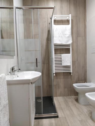 La salle de bains est pourvue d'une douche, d'un lavabo et de toilettes. dans l'établissement Gelsonero Apartments, à Ragalna