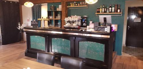 a bar with chairs and a counter in a room at Les Dineux Village in Trémeur
