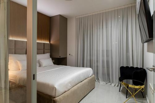 a bedroom with a bed and a table and a chair at Villa Nina - Apartments with pool near the sea in Rabac
