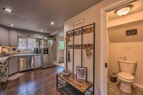 a kitchen with a sink and a toilet and a refrigerator at On the Rocks - A Modern Home with Decks and Views in Cloudcroft