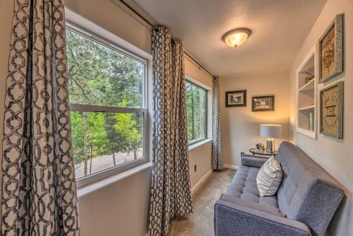 a living room with a couch and a large window at On the Rocks - A Modern Home with Decks and Views in Cloudcroft