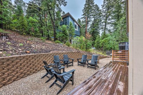a group of chairs sitting on a patio at On the Rocks - A Modern Home with Decks and Views in Cloudcroft
