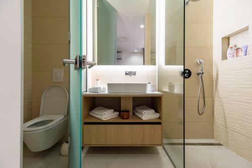 a bathroom with a sink and a toilet and a shower at Villa Nina - Apartments with pool near the sea in Rabac