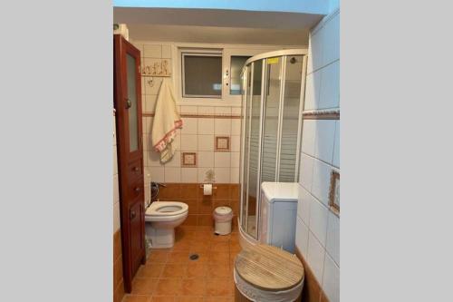 a bathroom with a toilet and a glass shower at CASA LOUKAS in Nerotriviá