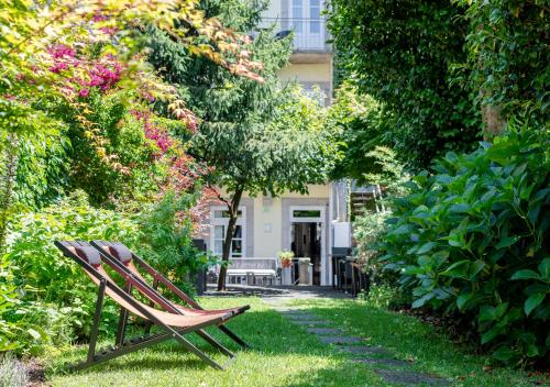 a lawn chair sits in front of a garden at Rosário Luxury Suites, by Oporto Collection & Free Parking in Porto