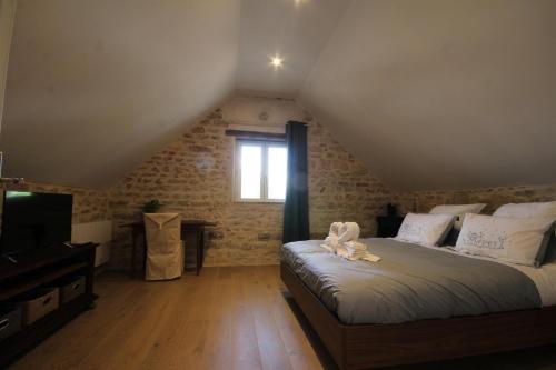 A bed or beds in a room at Le Clos Ligérien