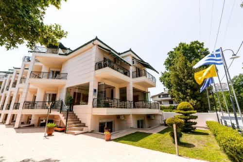 a building with flags in front of it at Stefanidis Platani Beach in Stavros