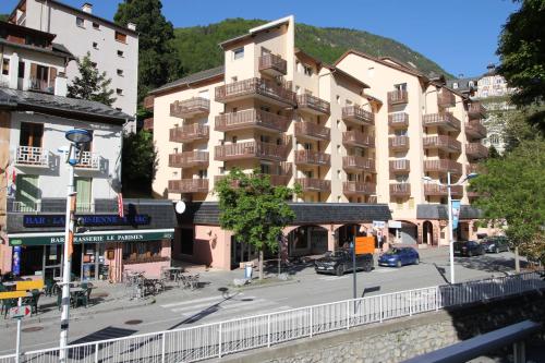 a building with balconies on a street in a city at ANTONIA2 in Brides-les-Bains