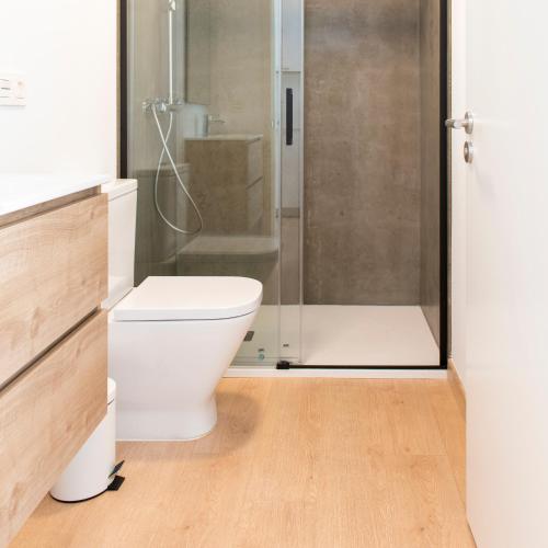 a bathroom with a toilet and a shower at Píllaras da Lanzada in A Lanzada