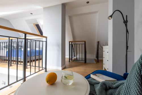 a living room with a table and a glass of wine at Apartamenty na wydmach in Łeba
