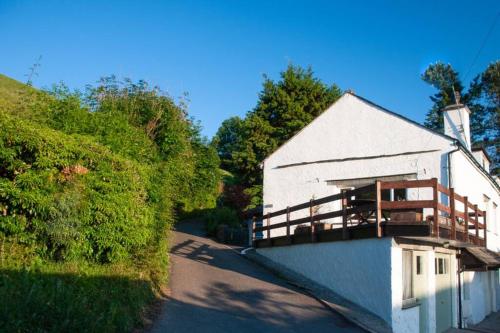 a white building with a balcony on the side of a road at Lane Foot Family accommodation Winter Deals Nov to March on 3 nts or more in Ambleside