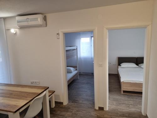a small room with a bed and a table at Aksa Residences in Vir