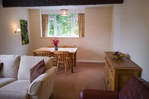 a living room with a couch and a table at Lane Foot Family accommodation Winter Deals Nov to March on 3 nts or more in Ambleside