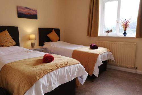 a hotel room with two beds with towels on them at Lane Foot Family accommodation Winter Deals Nov to March on 3 nts or more in Ambleside