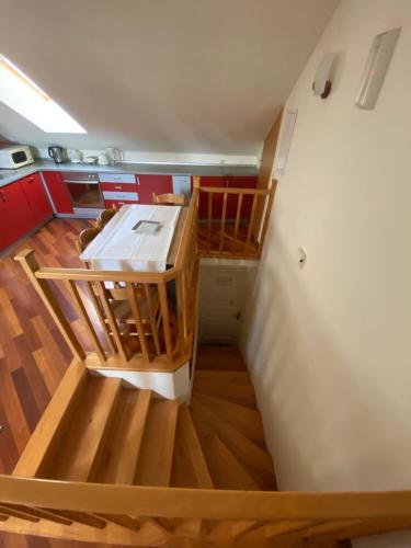 eine Küche mit Holzböden und einem weißen Kühlschrank in der Unterkunft Apartment Red Keep in Dubrovnik