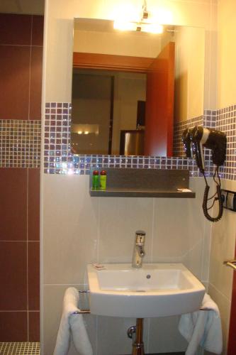 a bathroom with a sink and a mirror at Casablanca Suites - Adults Only in Calella