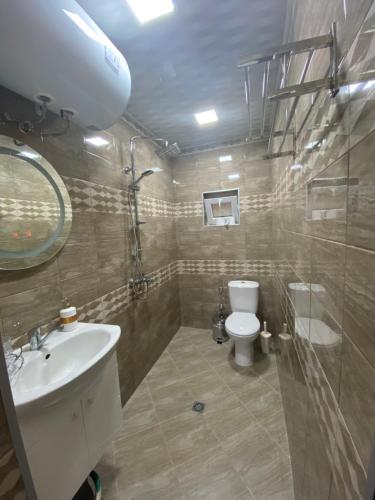 a bathroom with a toilet and a sink and a shower at При Наско in Shabla