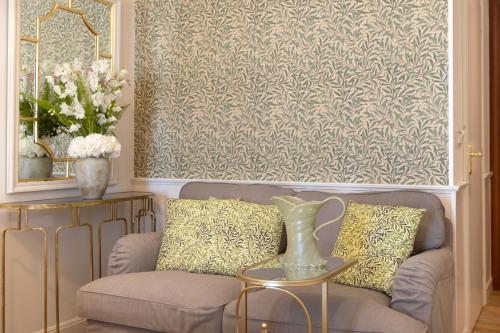 a living room with a couch and a wallpaper at Despotiko Hotel in Mýkonos City