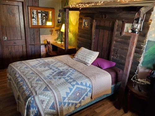 
a bedroom with a bed and a dresser at Brad's Desert Inn in Holbrook

