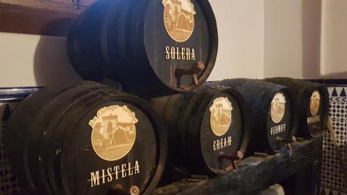 a group of wine barrels stacked on top of each other at Cortijo San José in Seville