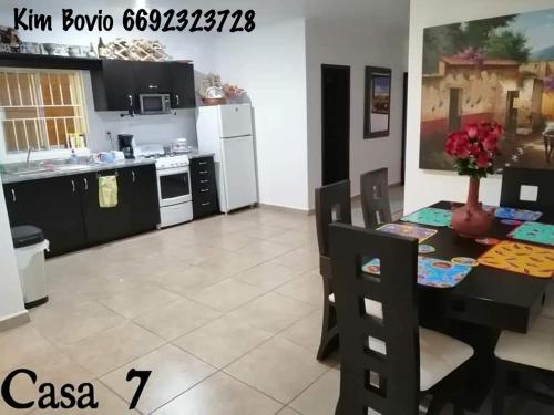 a kitchen and dining room with a table and chairs at Casa 7 in Mazatlán