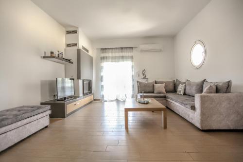a living room with a couch and a table at Meteora's Secret Garden House#1 in Kalabaka