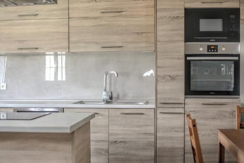a kitchen with a sink and a microwave at Meteora's Secret Garden House#1 in Kalabaka