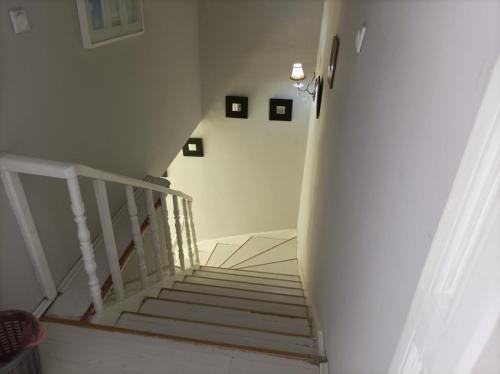 a stairway with white stairs and a white stair case at Citalna Rooms in Bitola