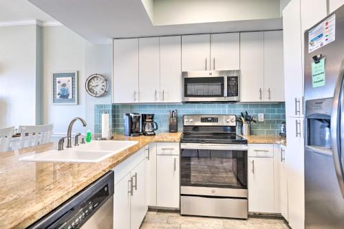 a kitchen with white cabinets and a sink at Tidewater 905 Orange Beach Condo Steps to Gulf! in Orange Beach