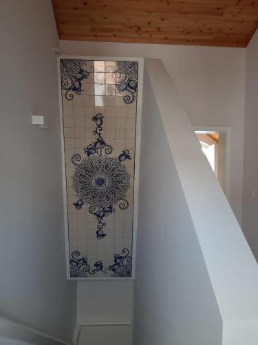 a staircase with a tile wall in a house at Penthouse Peaks - Casa Sao Joao -4 Star Tourist Apartments in Angra do Heroísmo