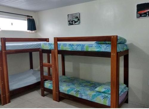 a room with three bunk beds in a room at Maresia Flats in Fortaleza