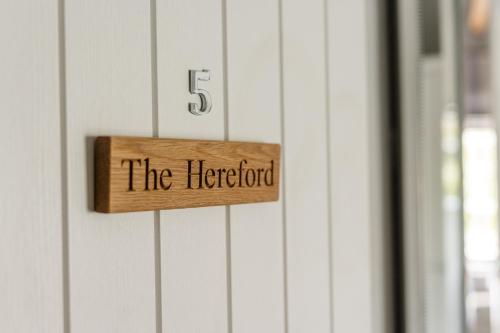 a wooden sign on a door with the herord at Plum and Partridge Husthwaite in York