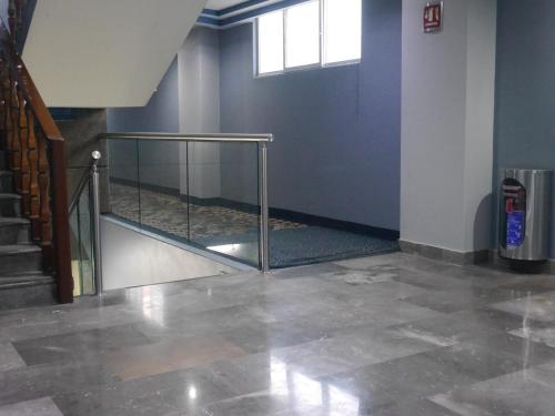 a stairwell with a glass railing in a building at Hotel El Senador in Mexico City