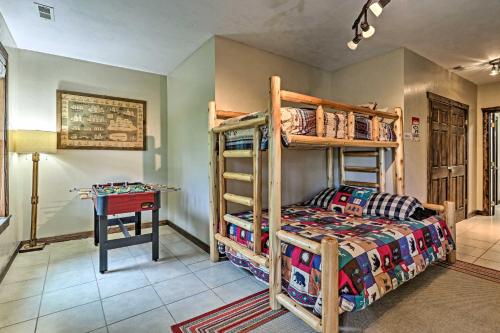 a bedroom with bunk beds and a desk at Beautiful Bryson City Home with Hot Tub and Mtn Views! in Bryson City