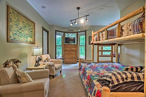 a bedroom with a bunk bed and a couch at Beautiful Bryson City Home with Hot Tub and Mtn Views! in Bryson City