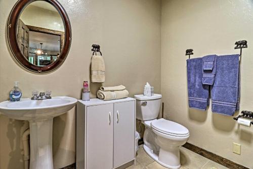 a bathroom with a sink and a toilet and a mirror at Beautiful Bryson City Home with Hot Tub and Mtn Views! in Bryson City