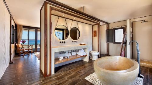 a bath room with a tub and a sink at Villa Santa Cruz in Todos Santos