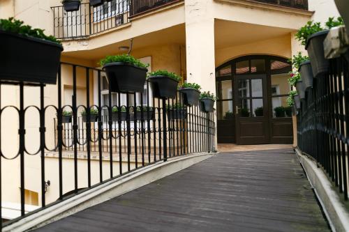 a fence with potted plants and a door at Pension U Lilie in Prague