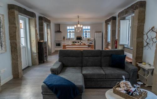 a living room with a couch and a kitchen at Sunrise - Casa Sao Joao - 4 Star Tourist Apartments in Angra do Heroísmo