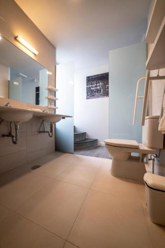 a bathroom with a sink and a toilet at Ocean - Casa Sao Joao - 4 Star Tourist Apartments in Angra do Heroísmo