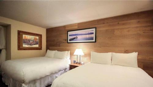 a hotel room with two beds and a picture on the wall at Postmarc Hotel and Spa Suites in South Lake Tahoe