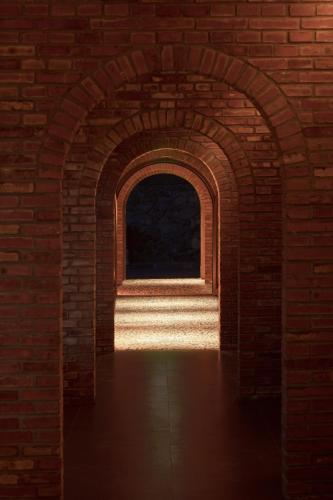 an archway in a brick wall with a window at Brickyard Retreat at Mutianyu Great Wall Adjoin to Mutianyu Great Wall - Room with the View of Great Wall - Chinese massage experience - Vehicle Shuttle Service - International Catering - SPA& Nail Beauty Facilities in Huairou