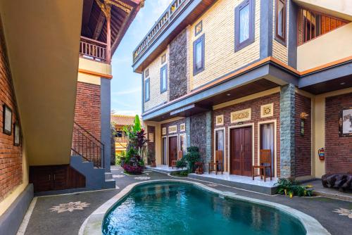 a swimming pool in the courtyard of a house at The Garuda Villa and Restaurant in Bedugul