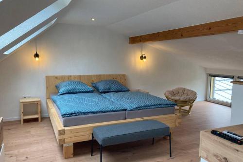 a bedroom with a large bed with blue pillows at Ferienwohnung zum Mandelgraben in Brauneberg
